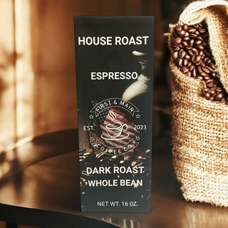 A bag of First And Main Coffee sitting on a counter with a burlap bag of coffee beans.